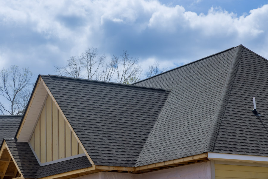 Gray architectural shingles across the gables and ridges of a residential roof